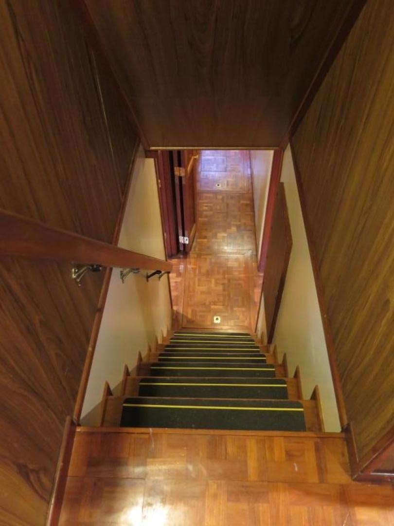 a wooden staircase with a railing aboard WANDERER Yacht for Sale