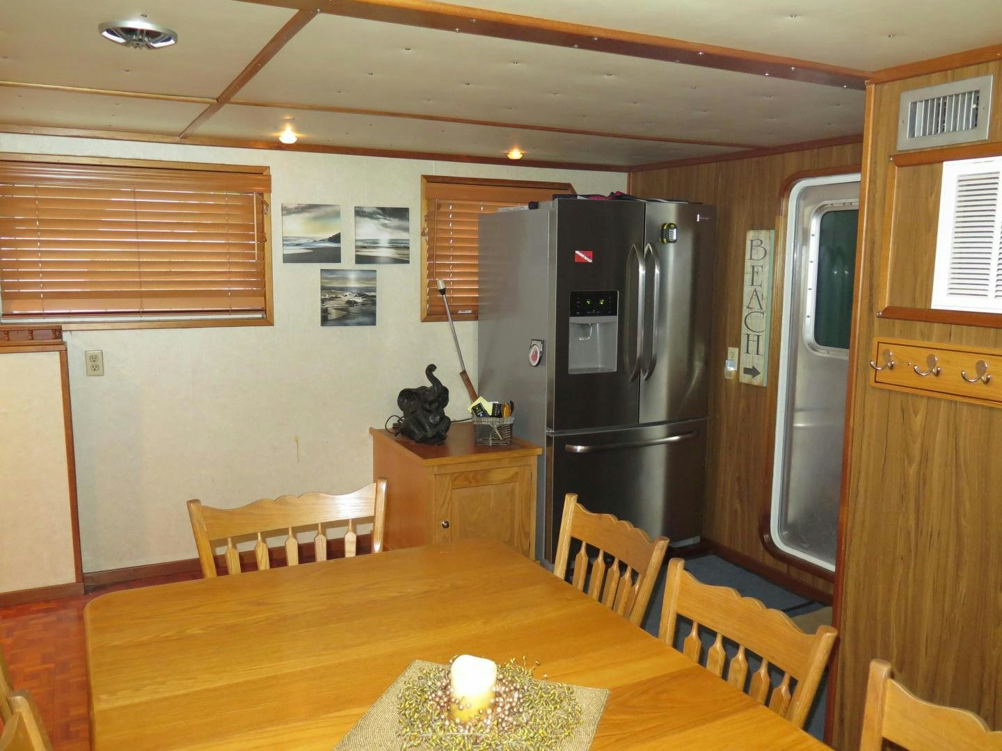 a kitchen with a fridge and a table aboard WANDERER Yacht for Sale
