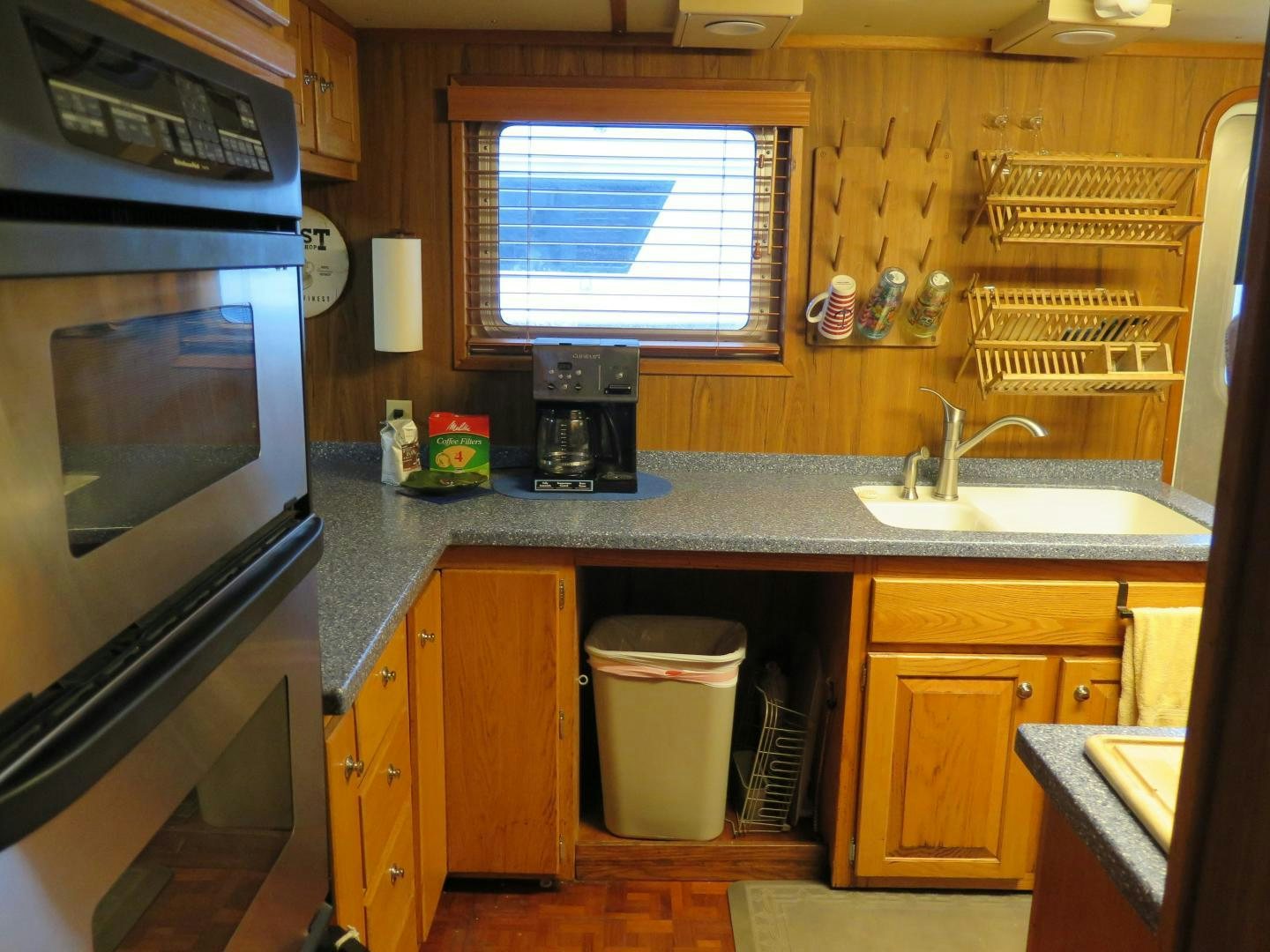 a kitchen with wooden cabinets aboard WANDERER Yacht for Sale