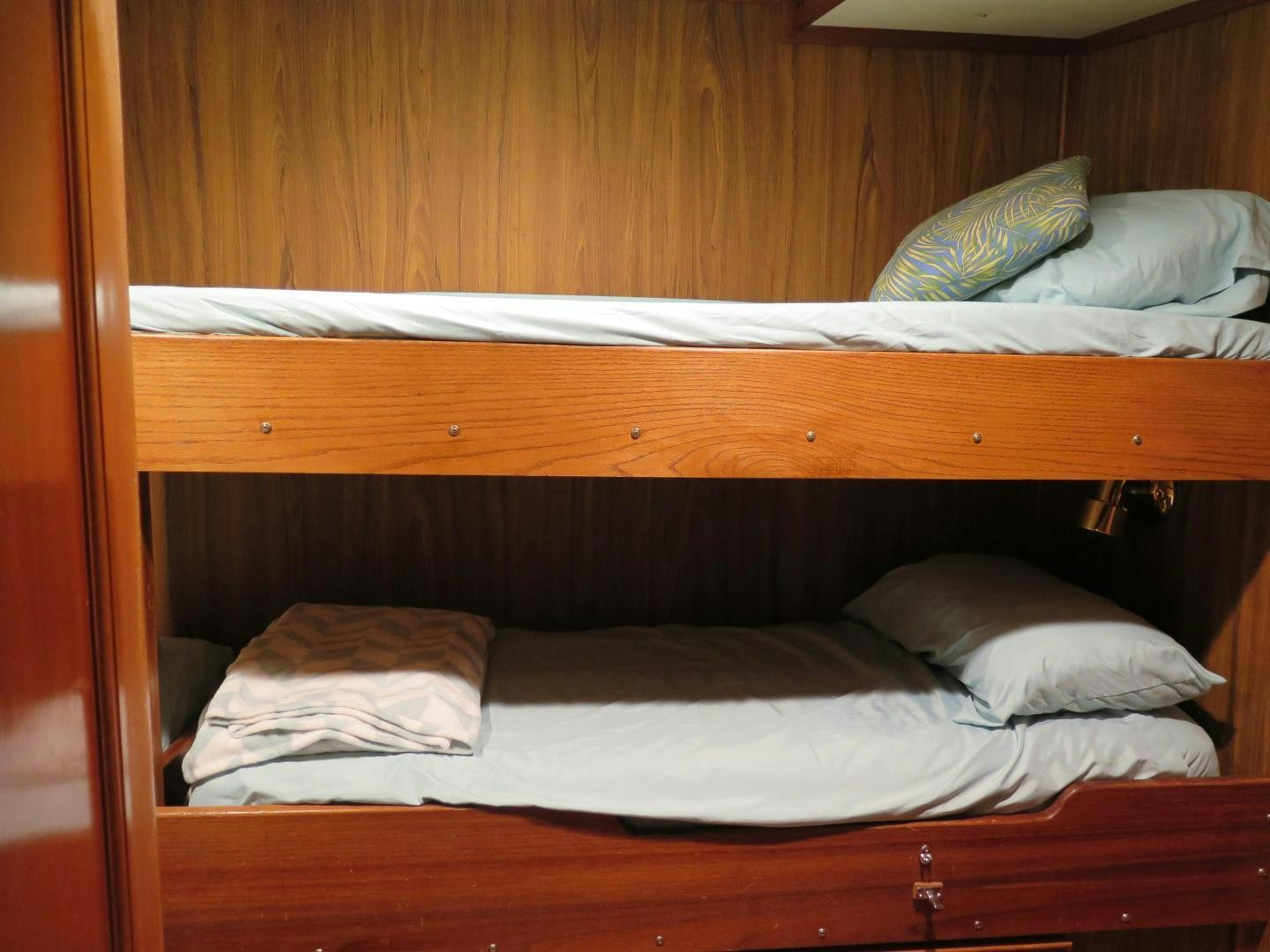a bed with a wooden headboard aboard WANDERER Yacht for Sale