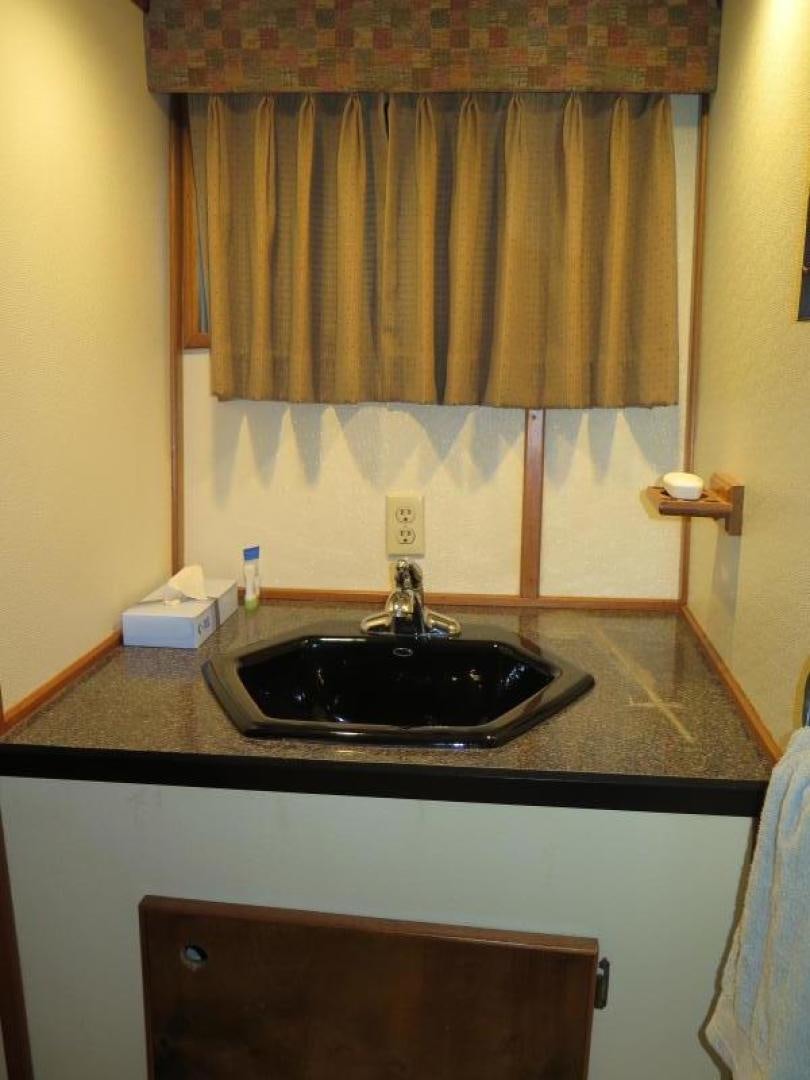 a bathroom with a sink and a mirror aboard WANDERER Yacht for Sale