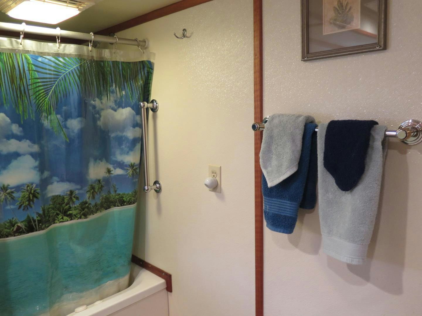 a bathroom with a shower curtain aboard WANDERER Yacht for Sale