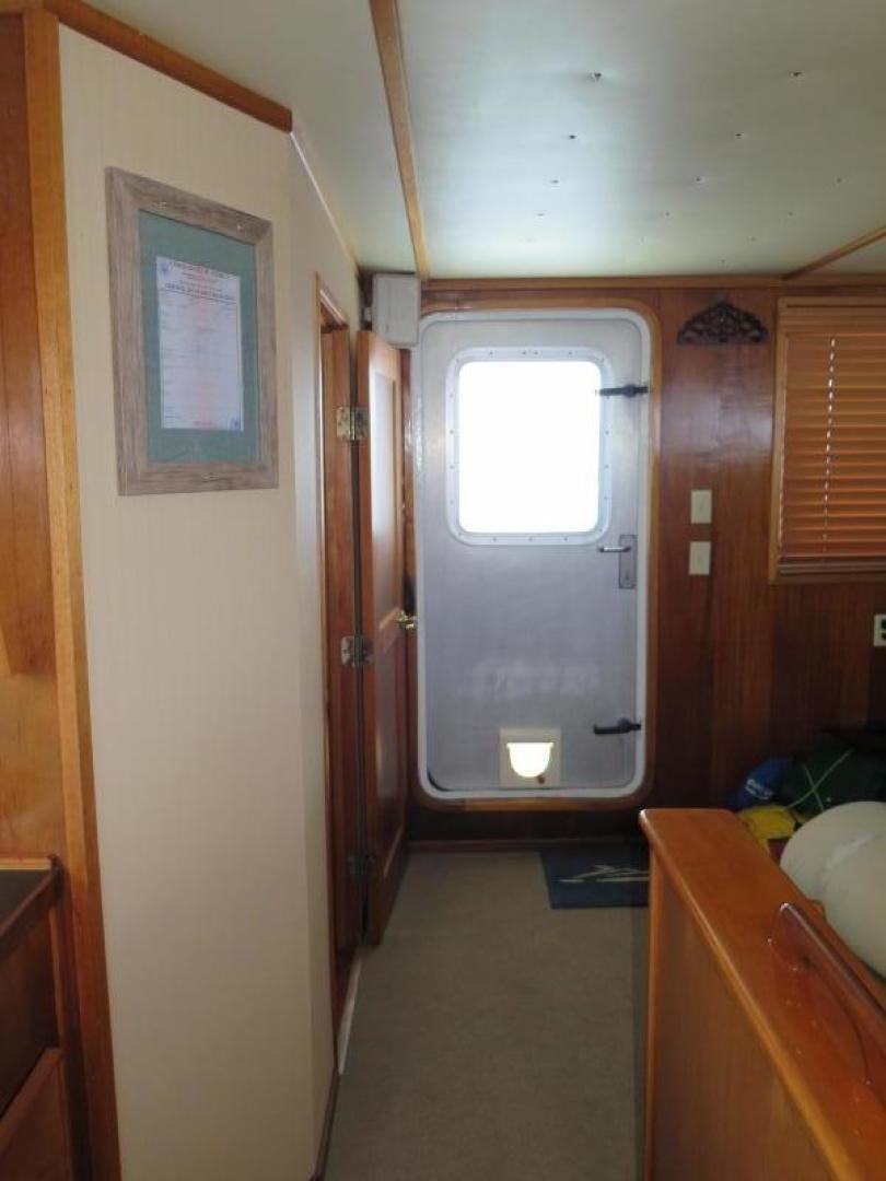 a room with a door and a window aboard WANDERER Yacht for Sale