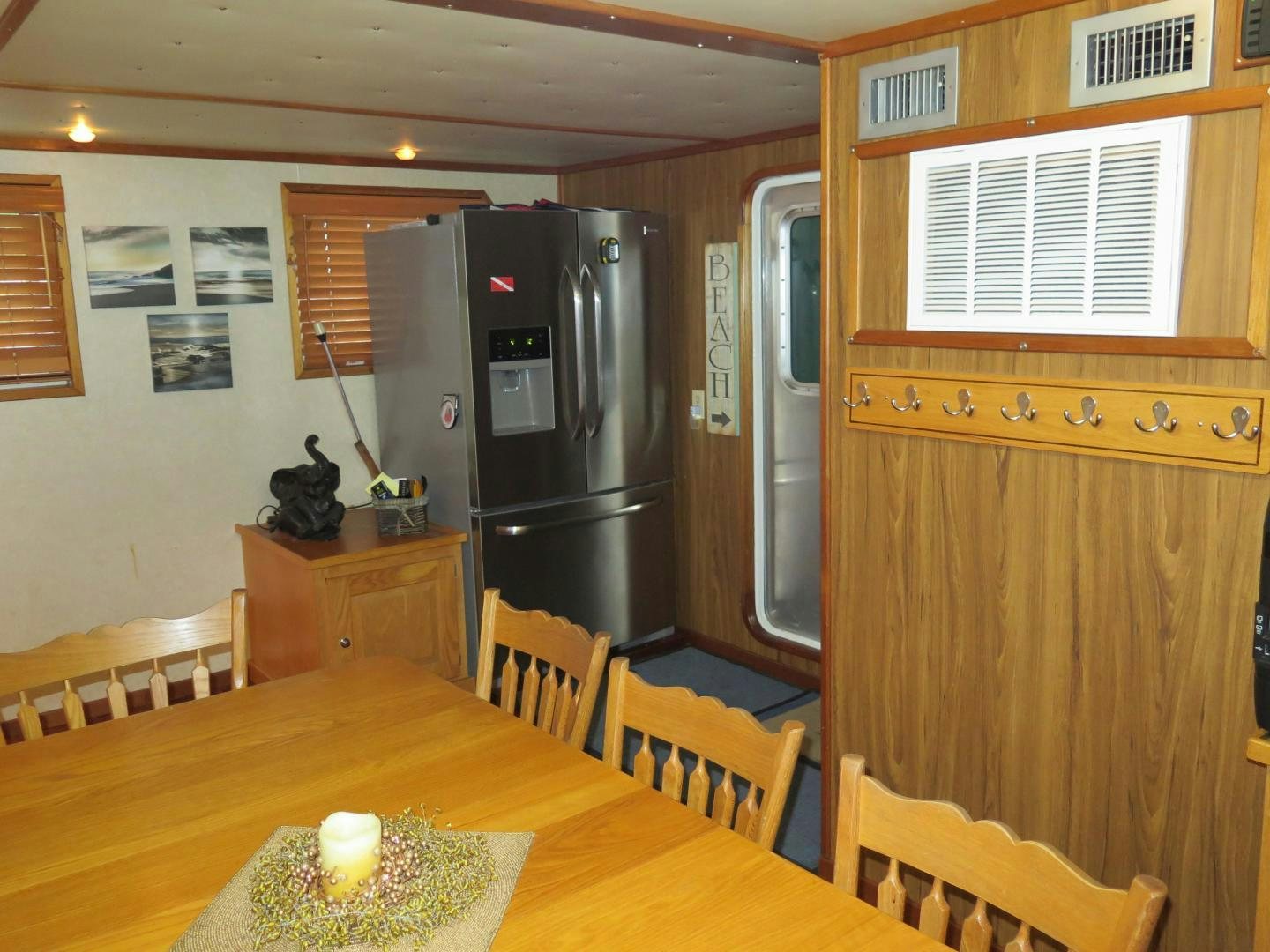 a kitchen with a fridge and a table aboard WANDERER Yacht for Sale