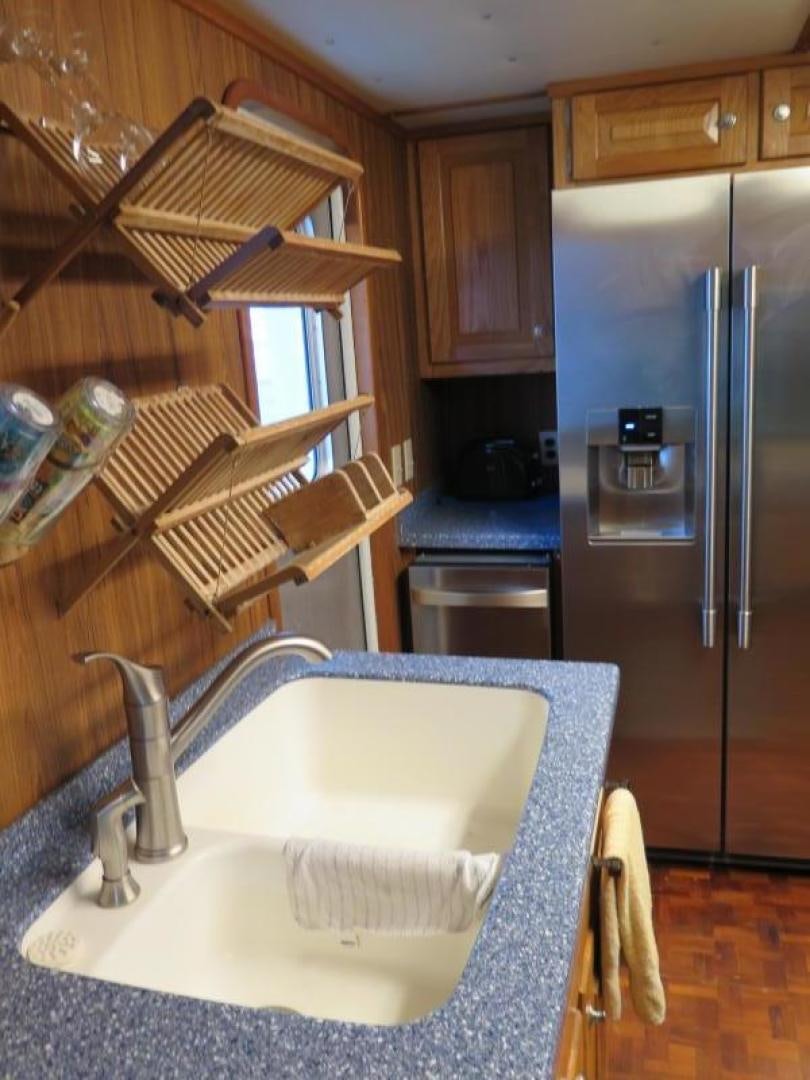 a kitchen with a sink and a refrigerator aboard WANDERER Yacht for Sale