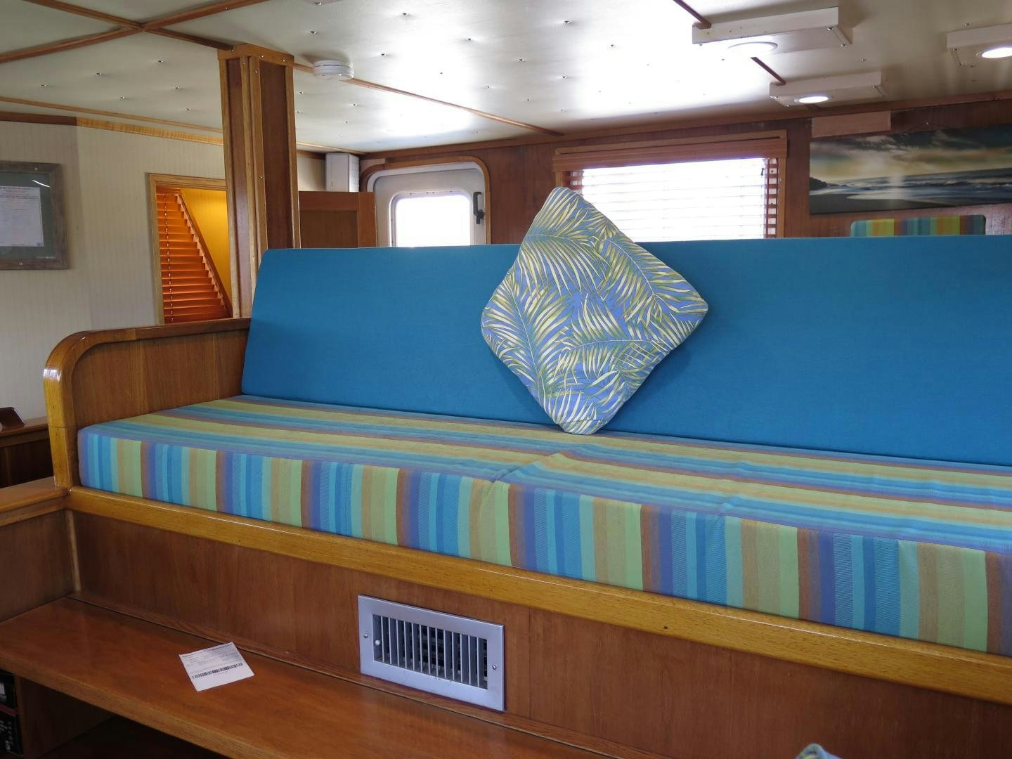 a bed with a blue blanket aboard WANDERER Yacht for Sale
