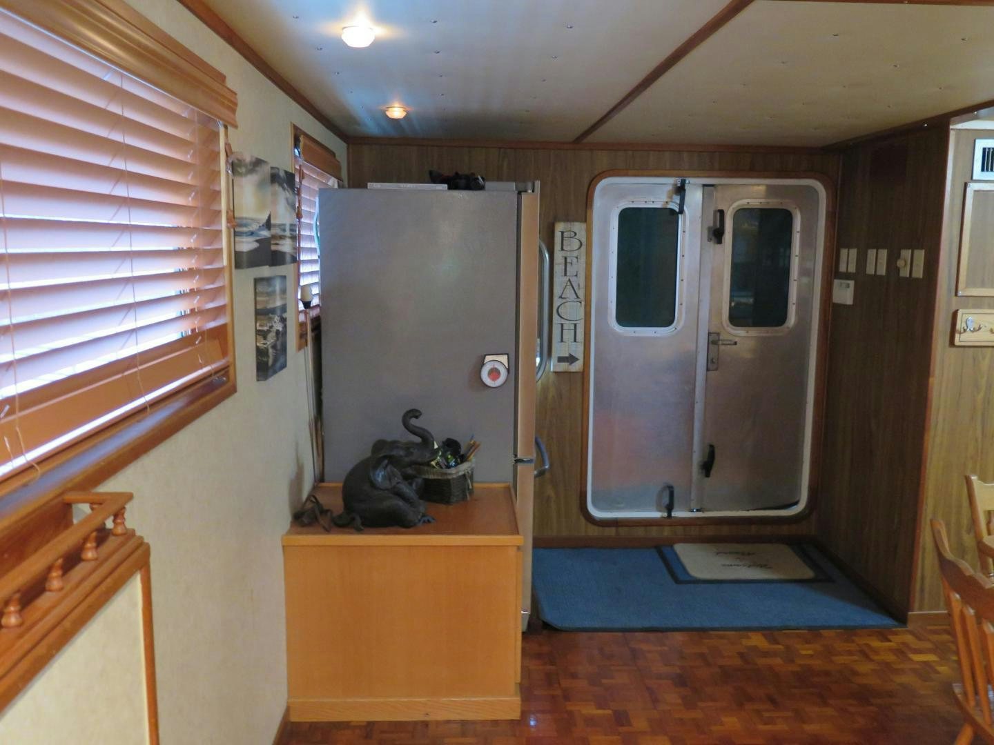 a room with a refrigerator and a door aboard WANDERER Yacht for Sale