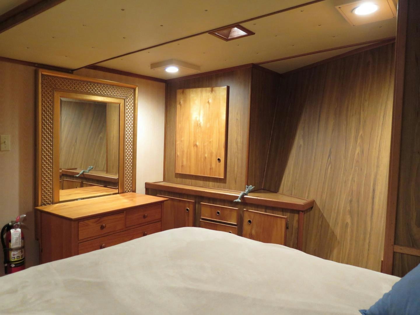 a room with a bed and a mirror aboard WANDERER Yacht for Sale
