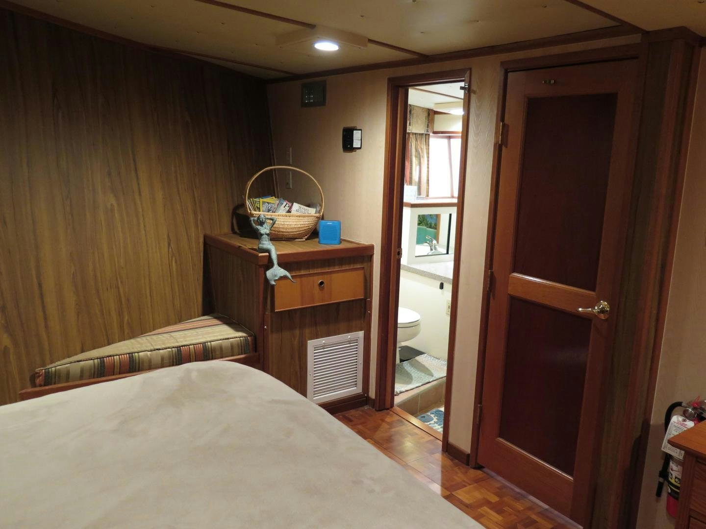 a bedroom with a bed and a sink aboard WANDERER Yacht for Sale