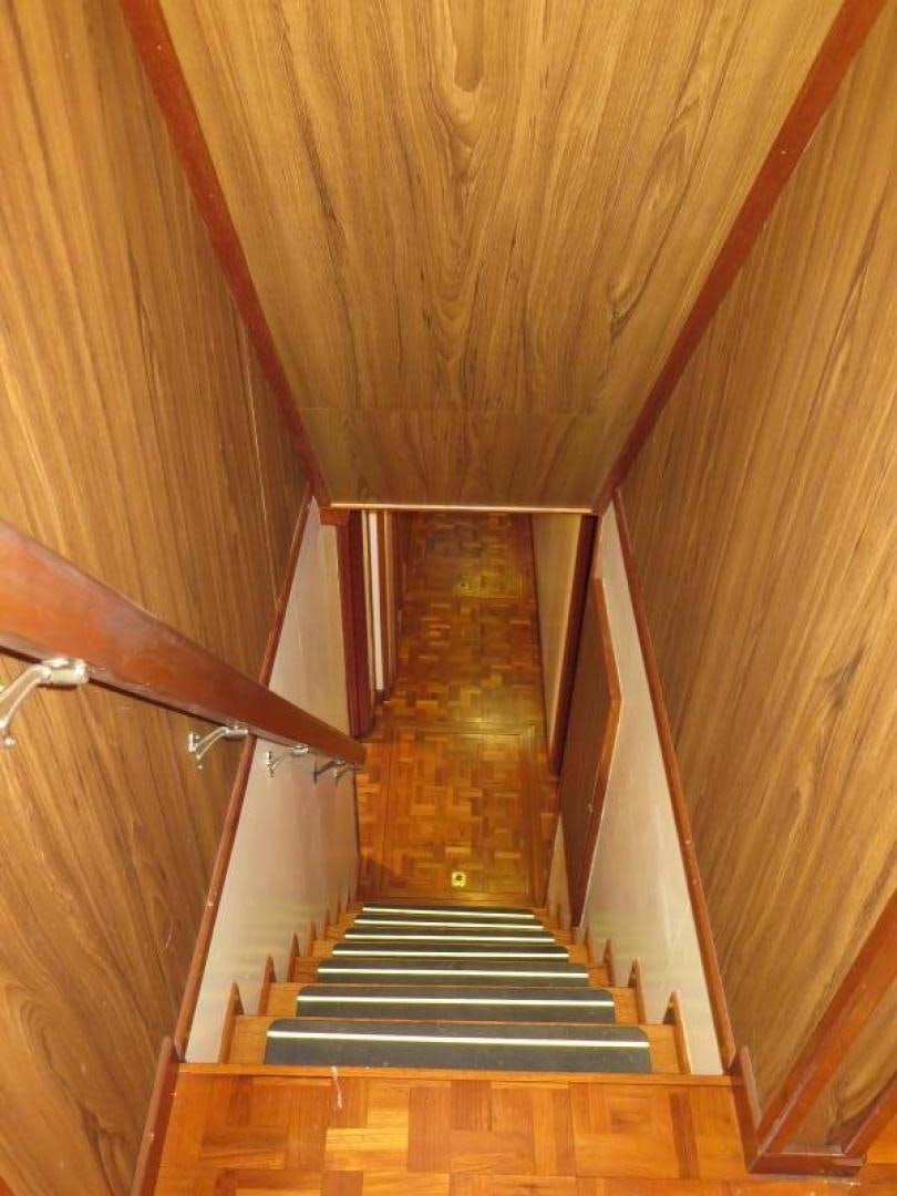 a wooden staircase with a railing aboard WANDERER Yacht for Sale