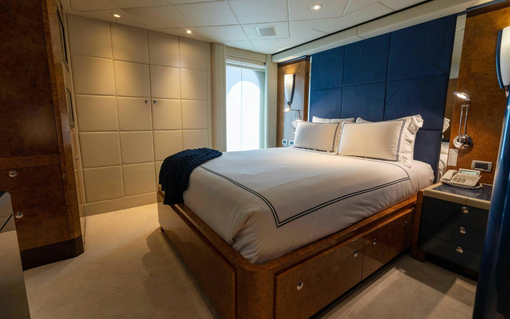a bedroom with a bed and a desk aboard 4 ROSES Yacht for Sale