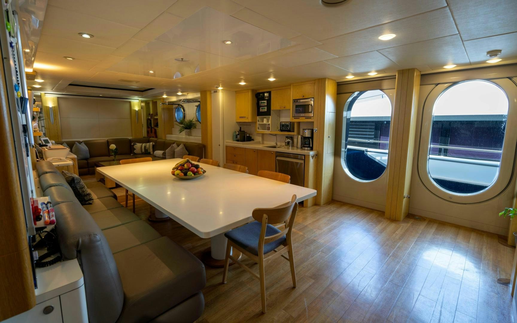 a large room with a table and chairs aboard 4 ROSES Yacht for Sale