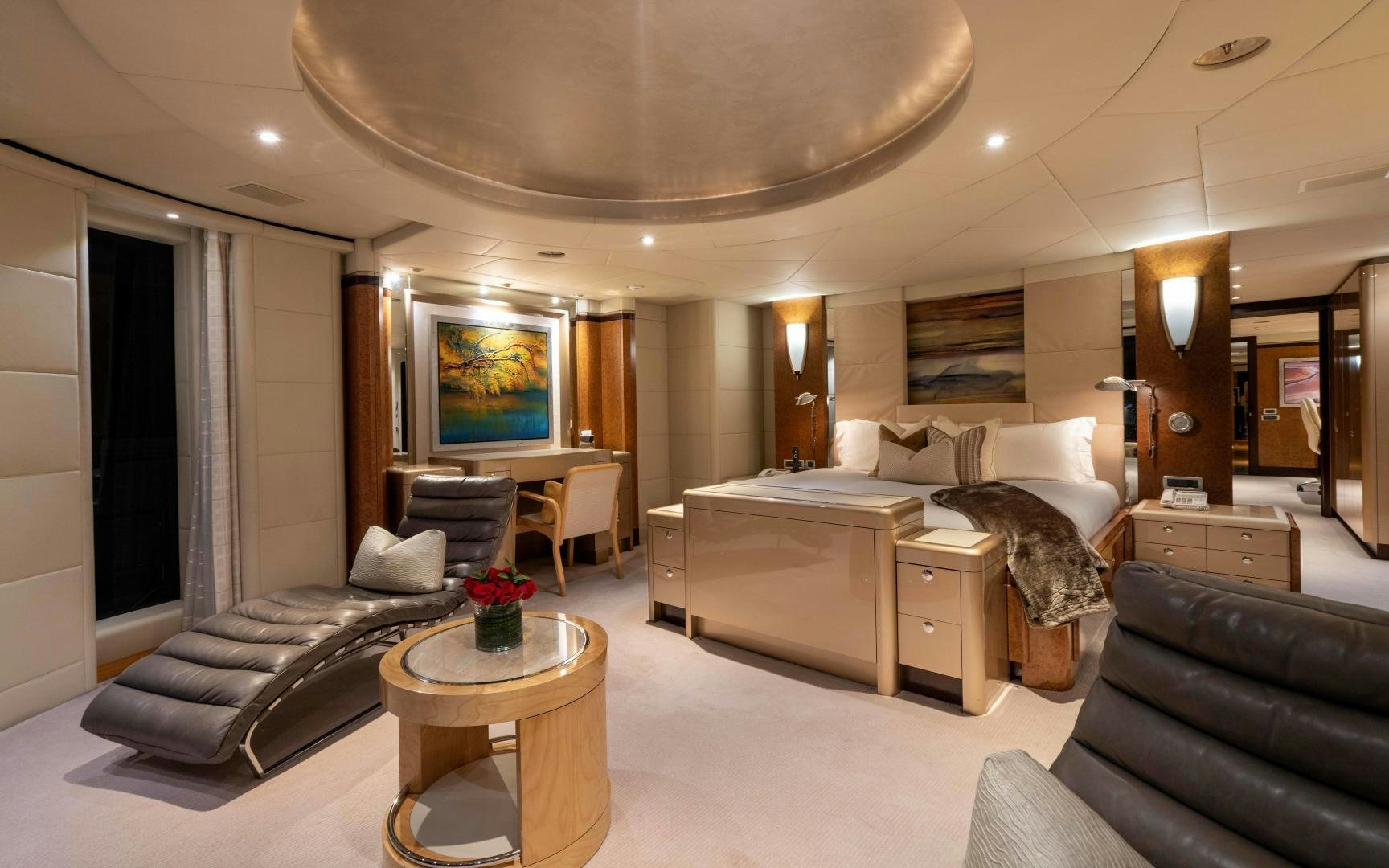 a living room with a large sofa and a coffee table aboard 4 ROSES Yacht for Sale