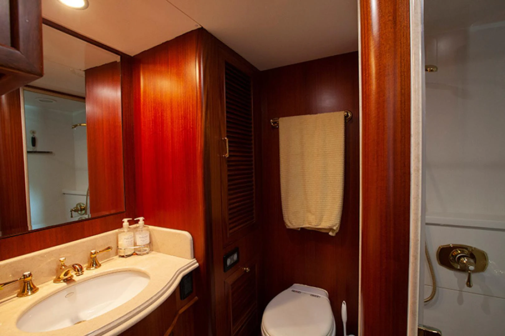 a bathroom with a toilet and sink aboard RHAPSODY Yacht for Sale
