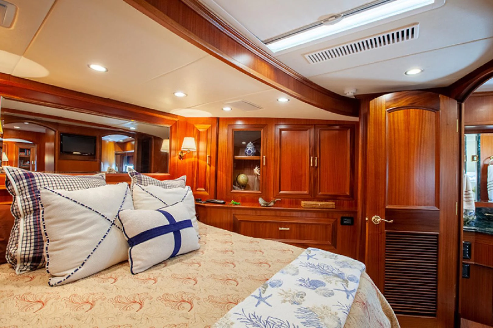 a large bedroom with wood cabinets aboard RHAPSODY Yacht for Sale