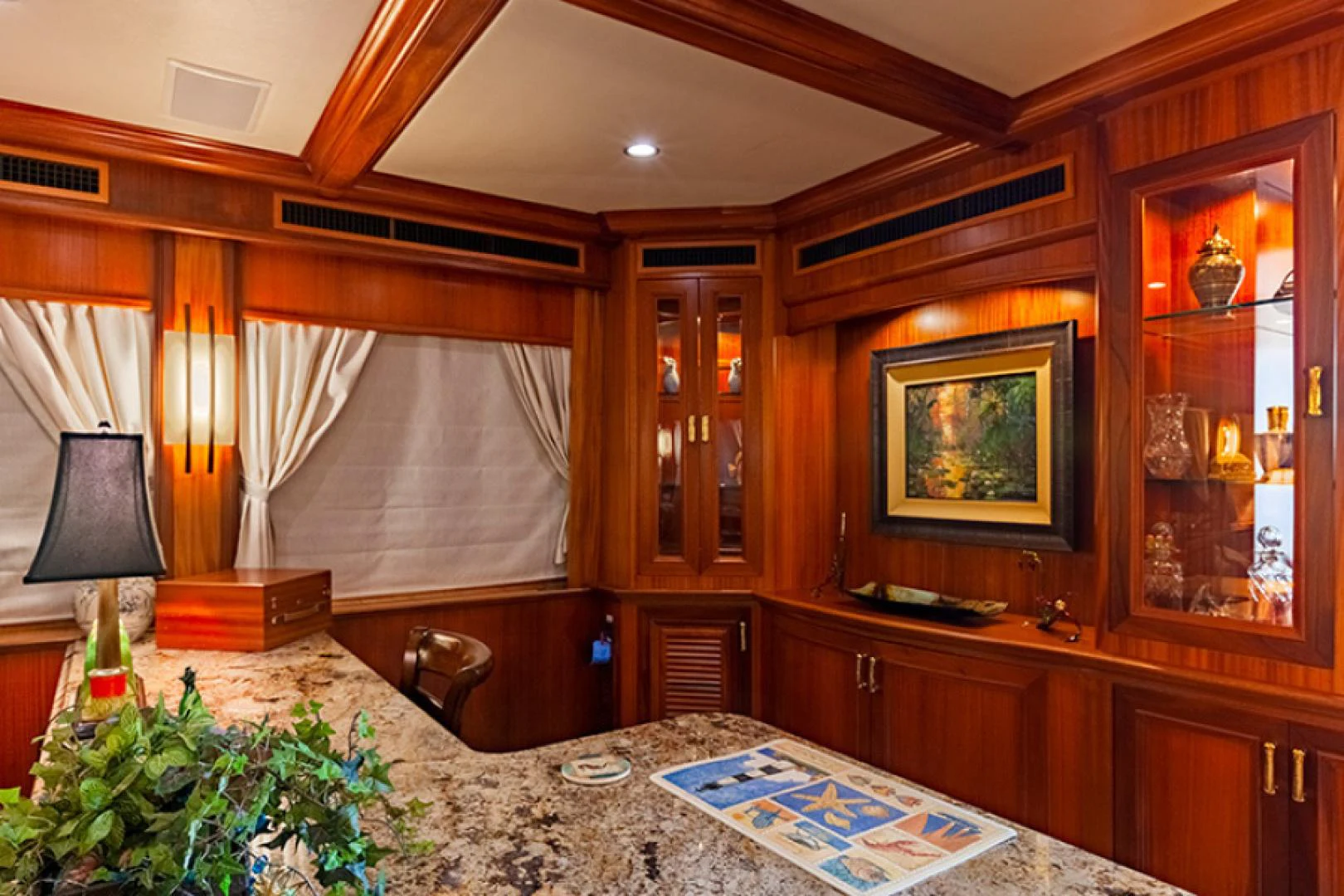 a room with a table and a lamp aboard RHAPSODY Yacht for Sale