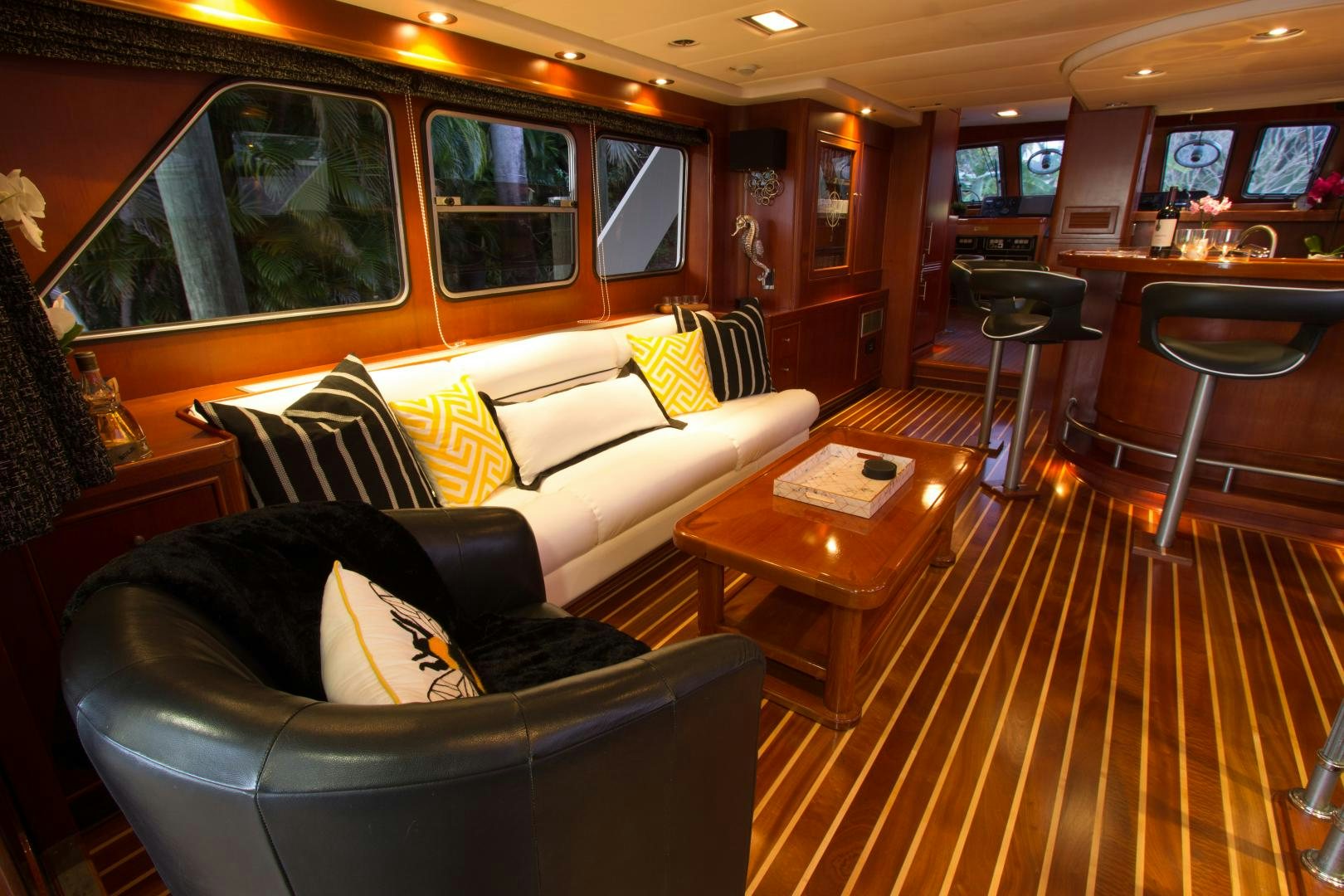 a living room with leather couches aboard SEAEO Yacht for Sale