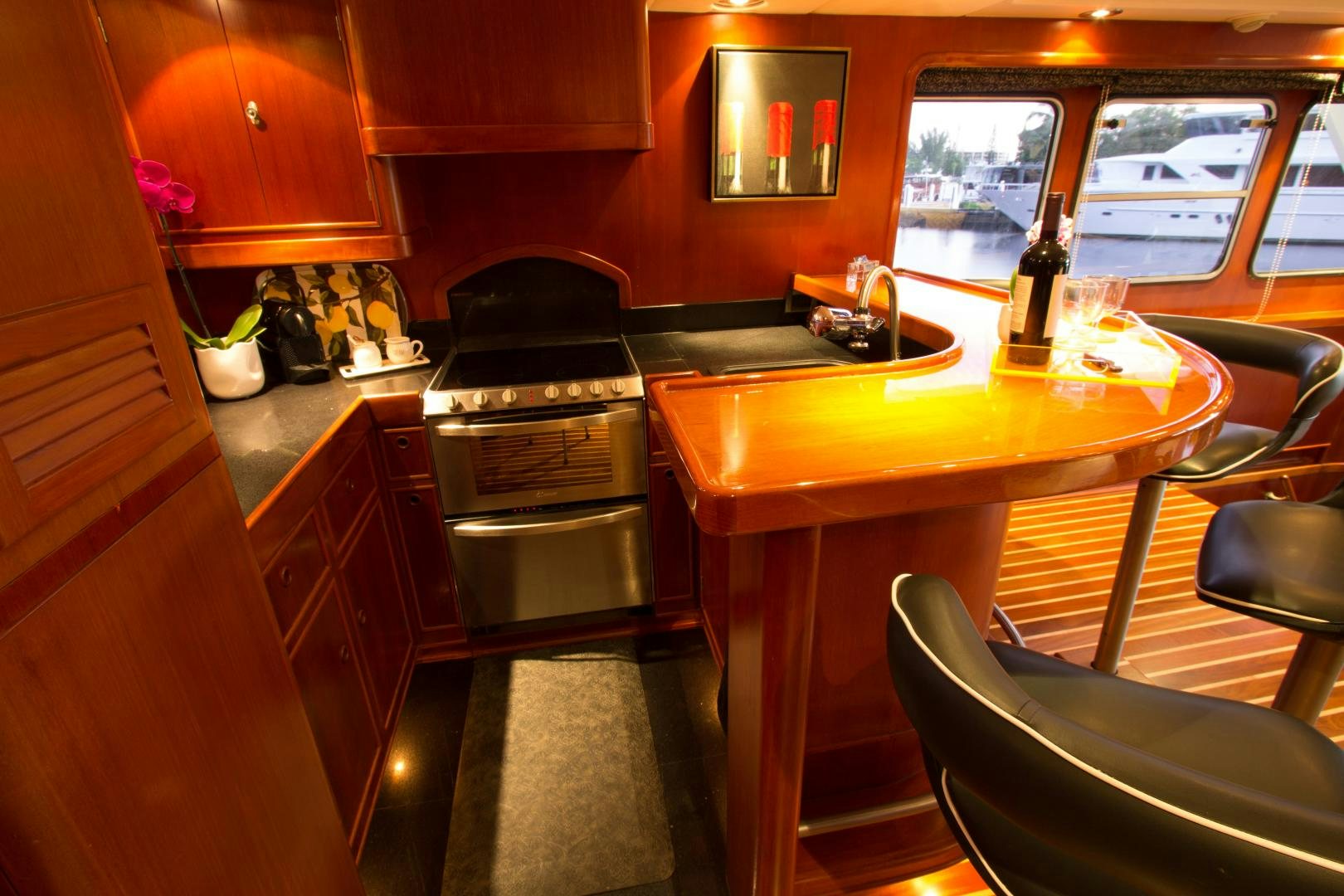 a kitchen with a table and chairs aboard SEAEO Yacht for Sale
