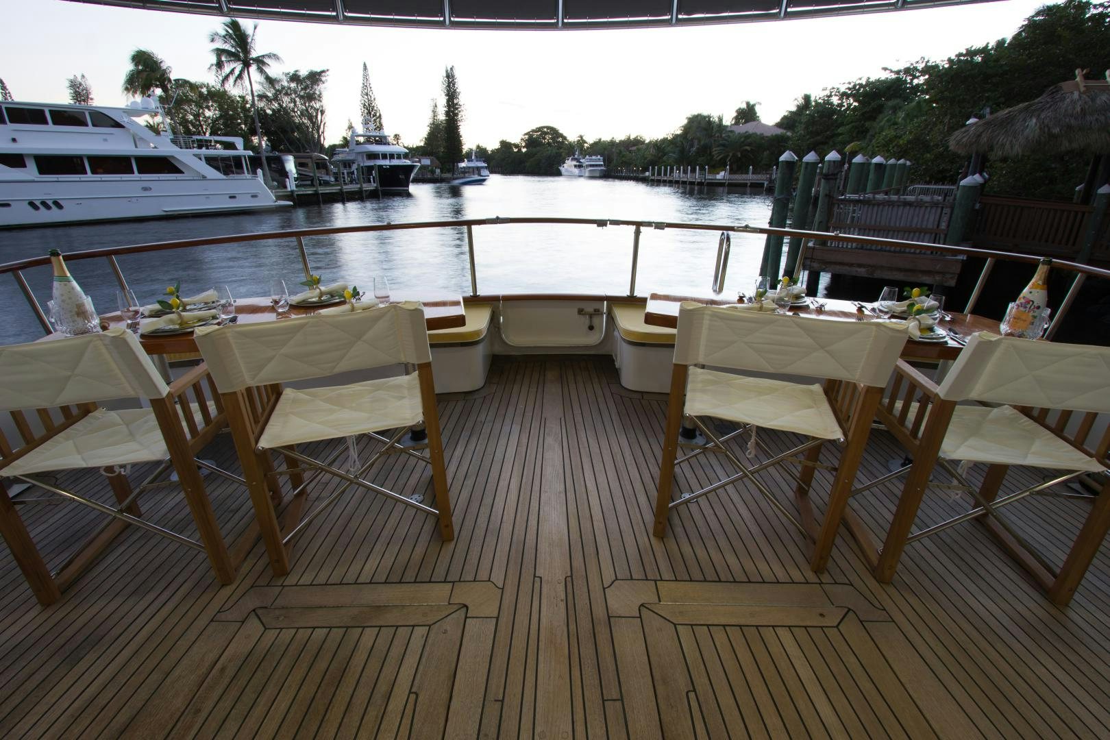 a deck with tables and chairs aboard SEAEO Yacht for Sale