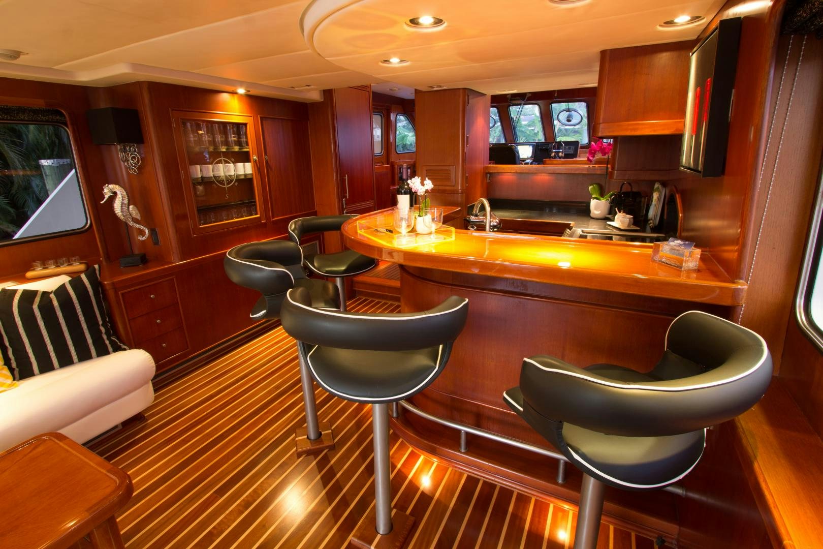 a kitchen with a bar stools and a bar stool aboard SEAEO Yacht for Sale