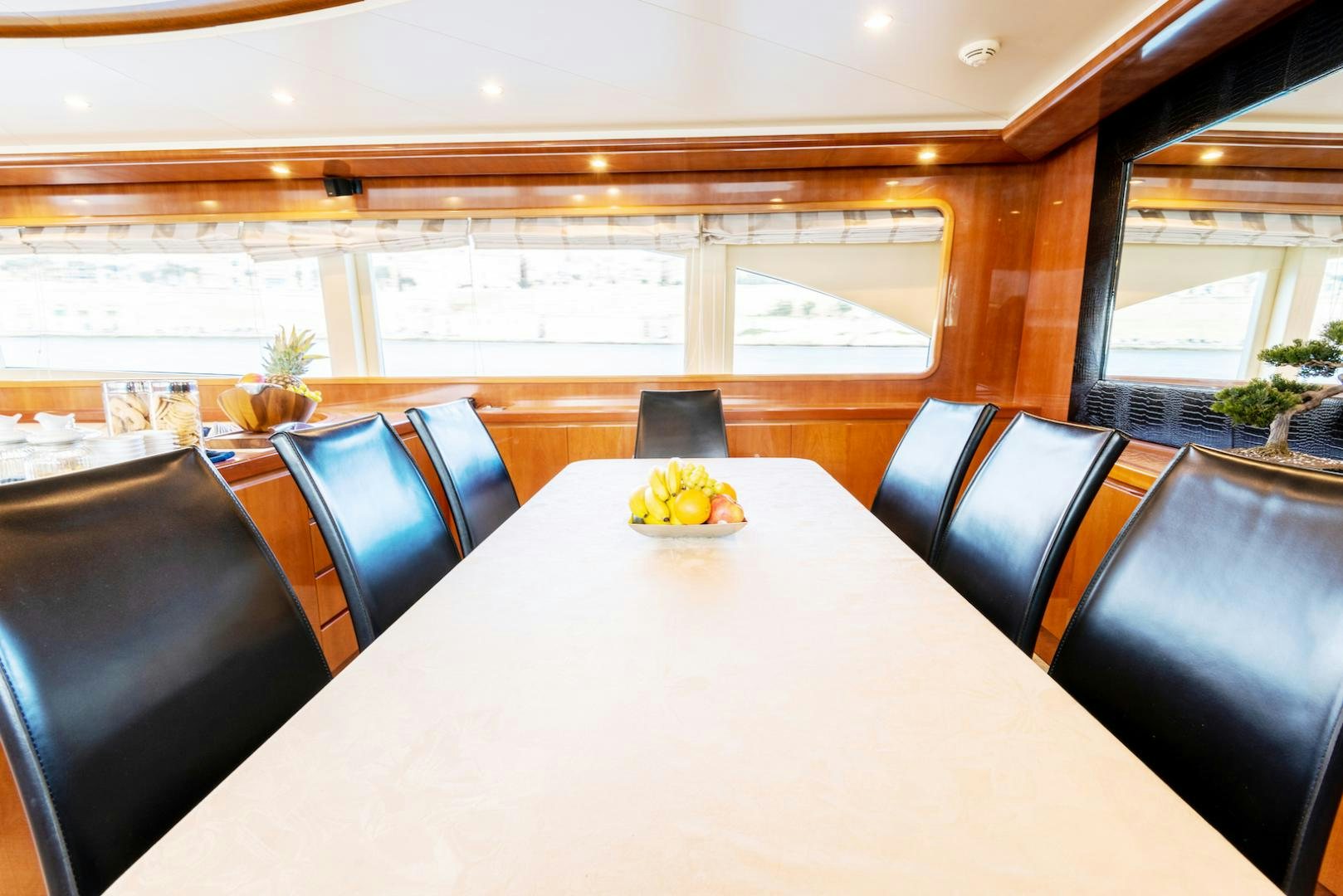 a table with chairs and a large window aboard SEA FALCON Yacht for Sale