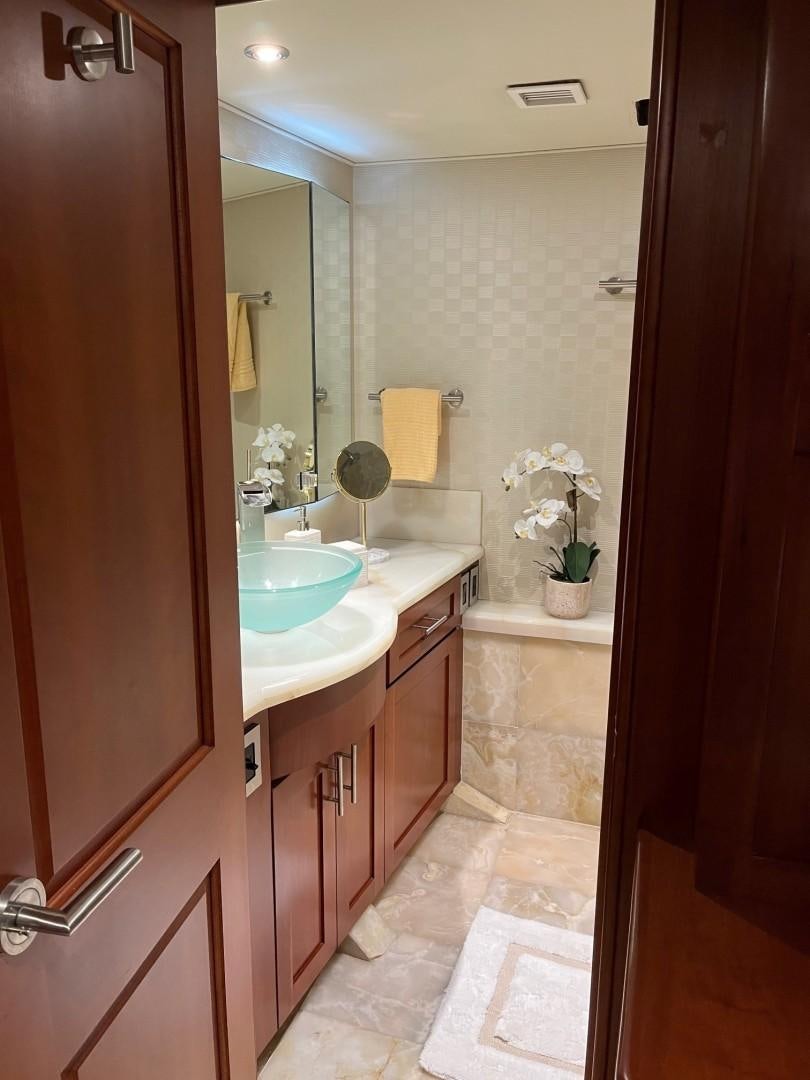 a bathroom with a sink and a mirror aboard CORDINA Yacht for Sale
