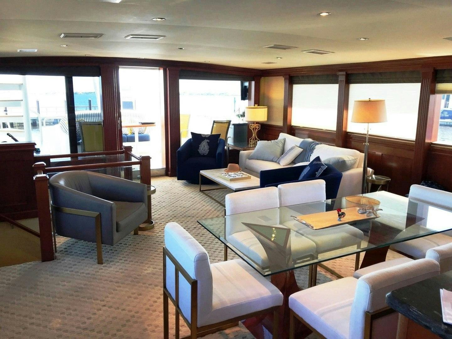 a living room with a couch and a table aboard CORDINA Yacht for Sale