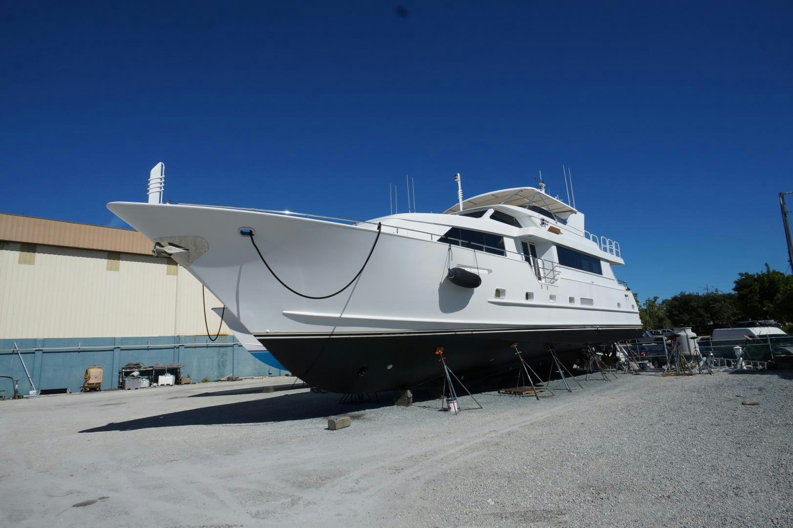a white yacht on a beach aboard CORDINA Yacht for Sale