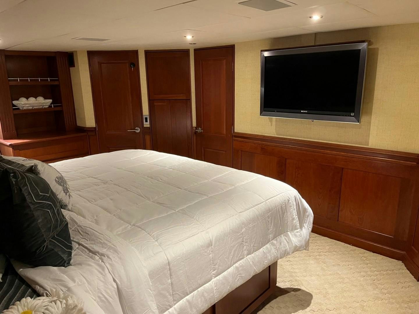 a bedroom with a bed and tv aboard CORDINA Yacht for Sale