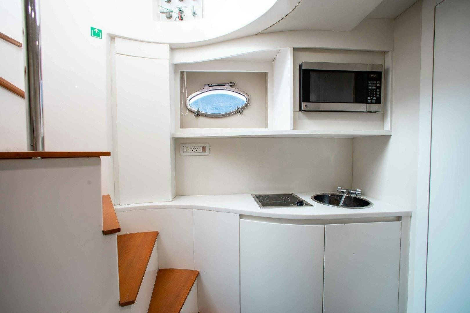a small kitchen with a microwave oven aboard JULIE K Yacht for Sale