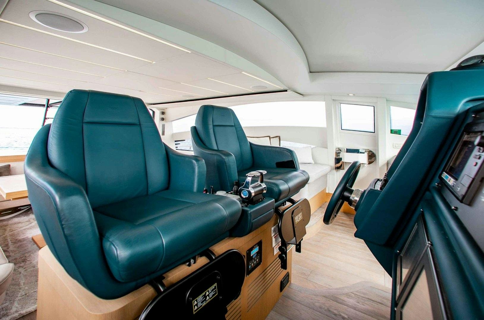 a room with seats and a table aboard JULIE K Yacht for Sale