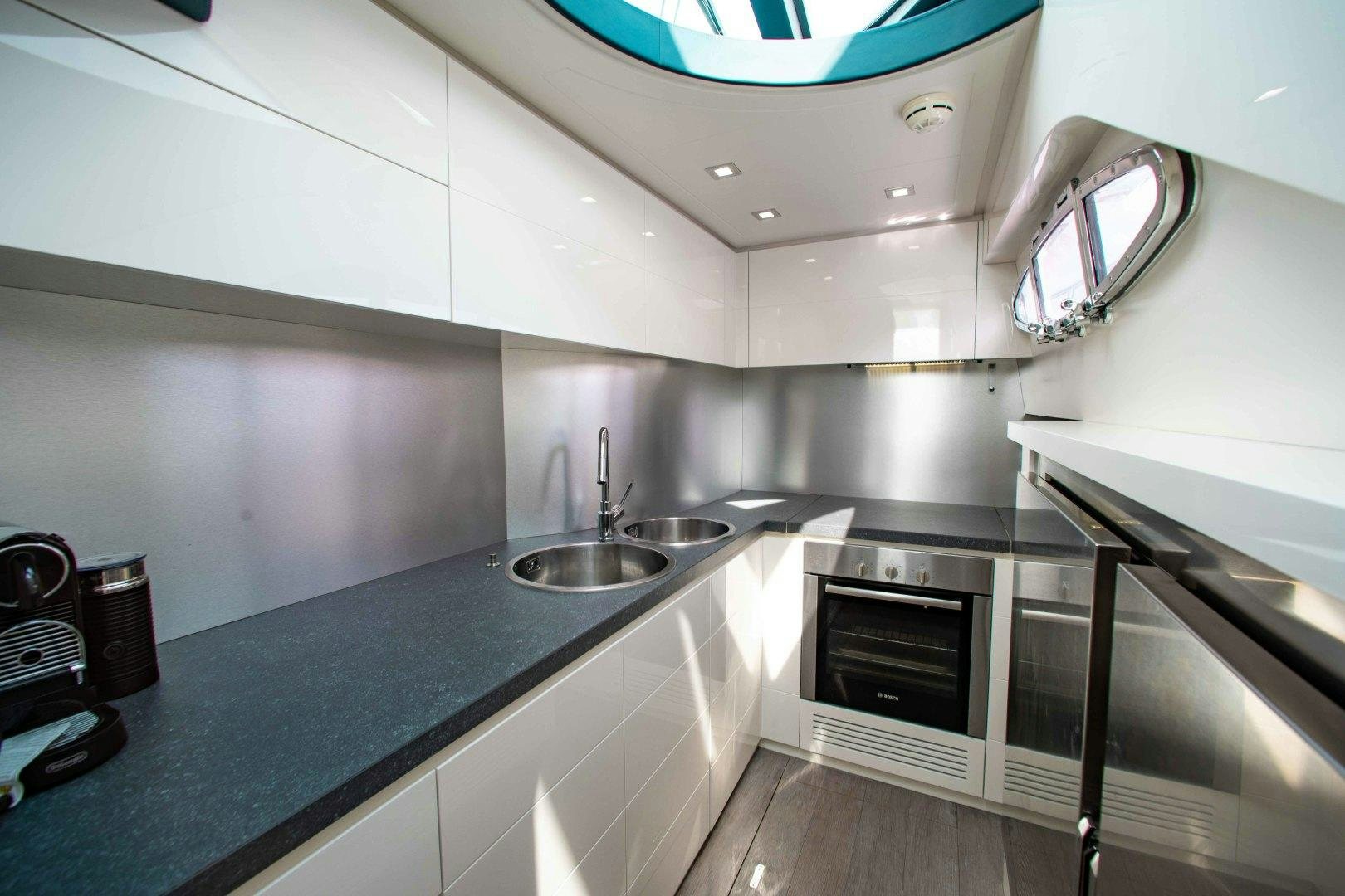 a kitchen with a black countertop aboard JULIE K Yacht for Sale
