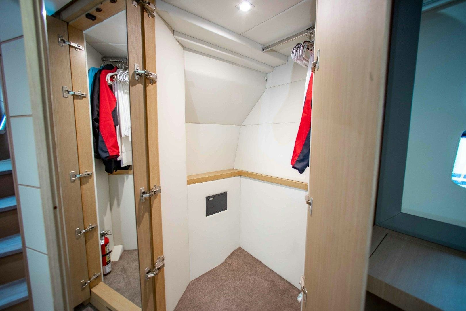 a bathroom with a closet and a door aboard JULIE K Yacht for Sale