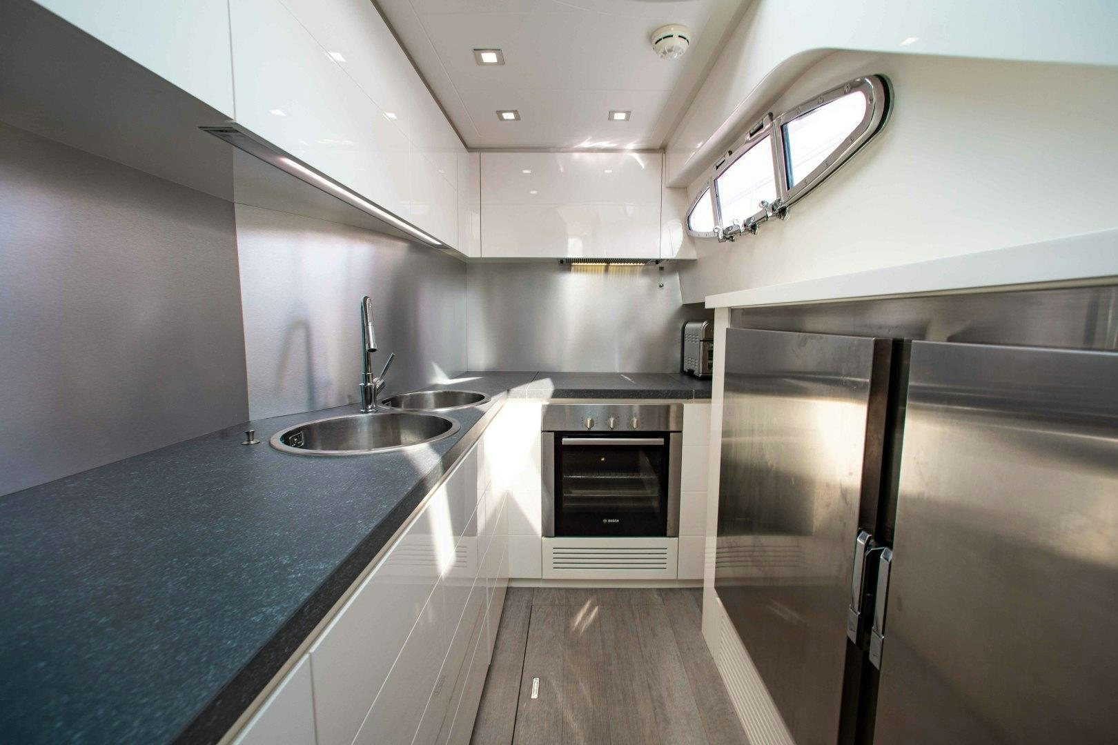 a kitchen with a sink and stove aboard JULIE K Yacht for Sale