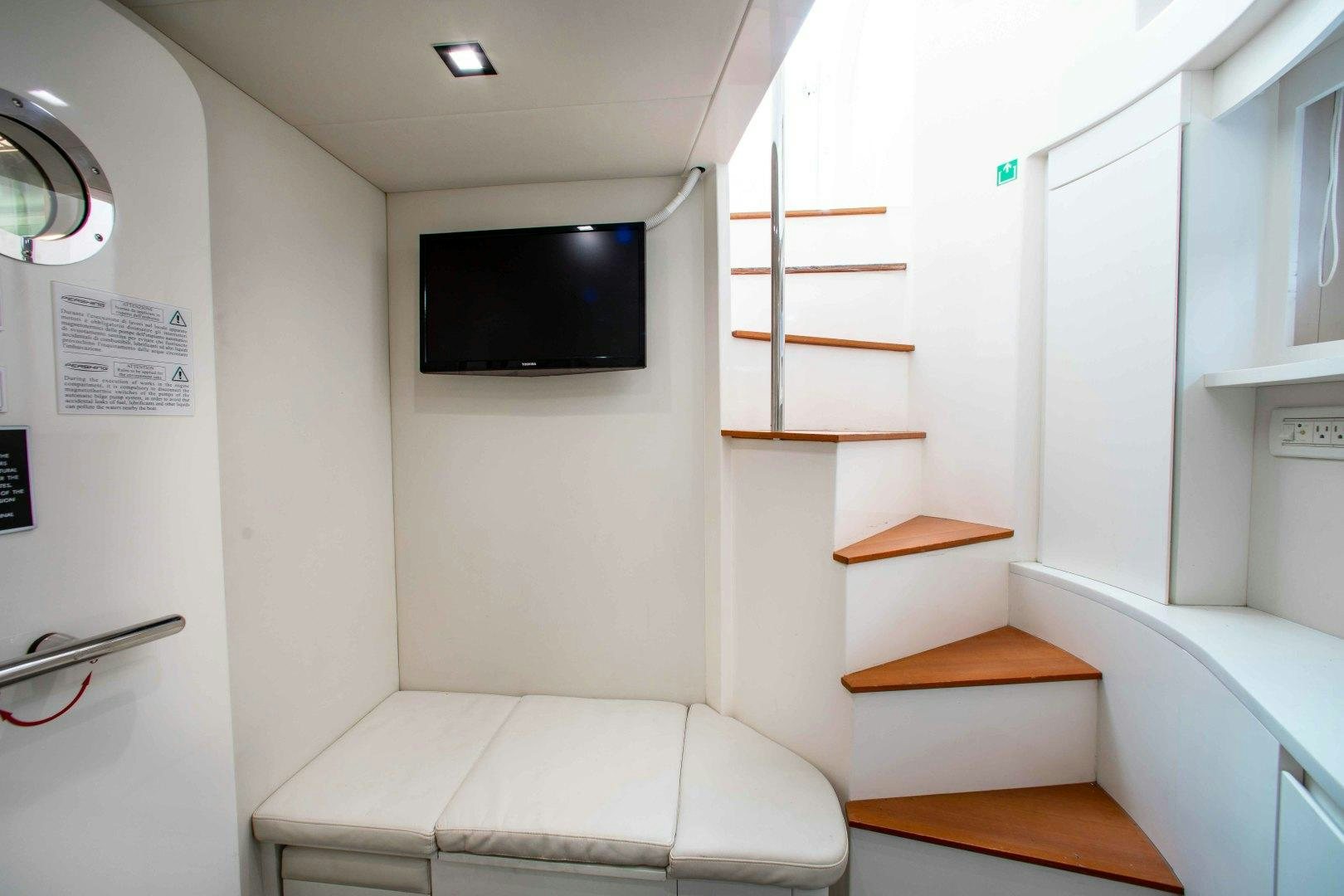 a room with a tv and a couch aboard JULIE K Yacht for Sale