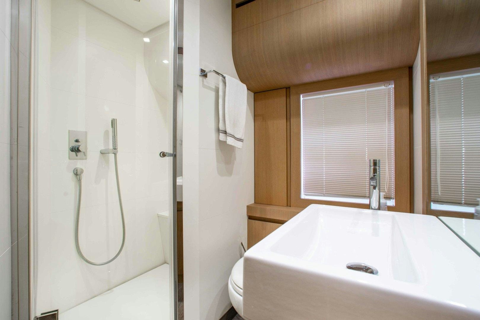 a bathroom with a tub sink and toilet aboard JULIE K Yacht for Sale