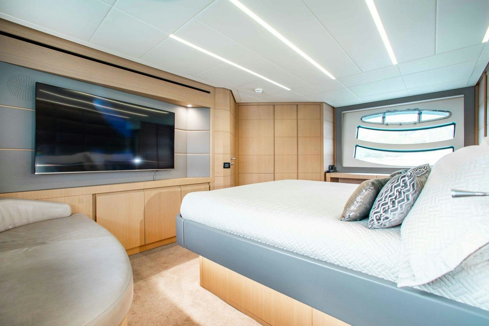 a room with a bed and a television aboard JULIE K Yacht for Sale