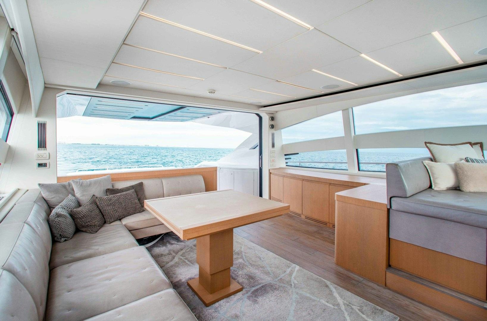 a room with a couch and a table and a pool aboard JULIE K Yacht for Sale