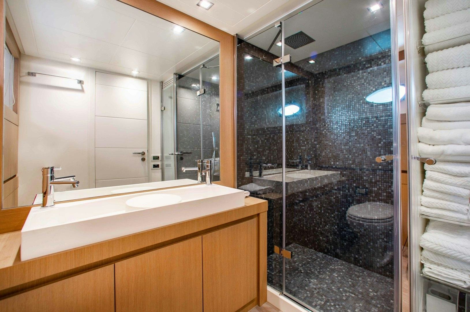 a bathroom with a large mirror aboard JULIE K Yacht for Sale