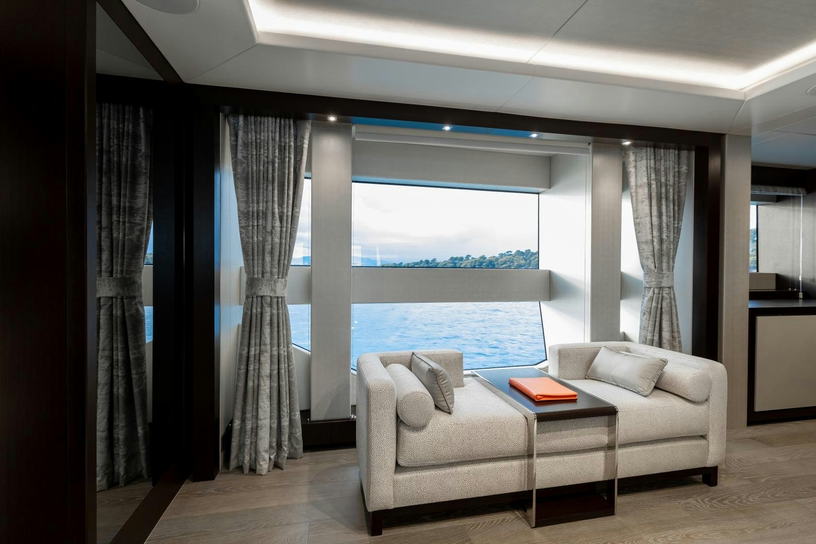 a living room with a large window aboard SEDATIVE Yacht for Sale