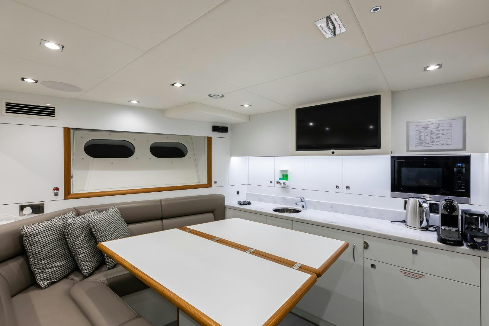 a kitchen with a couch and a tv aboard SEDATIVE Yacht for Sale
