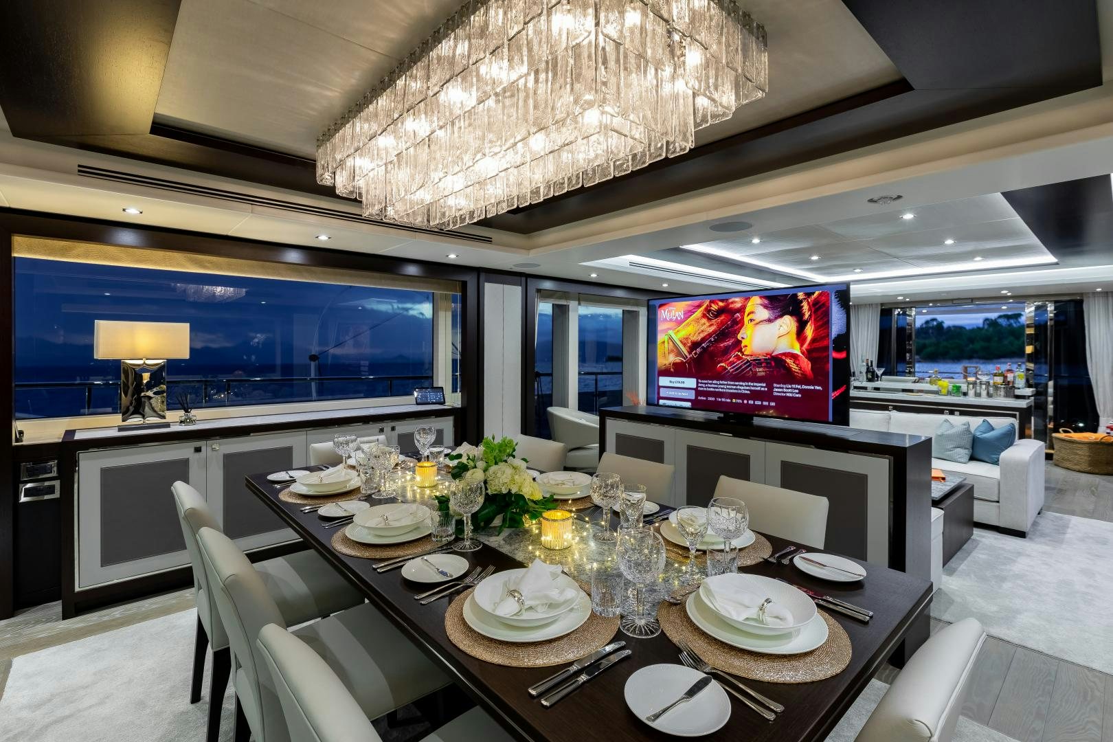 a large dining room with a large screen aboard SEDATIVE Yacht for Sale