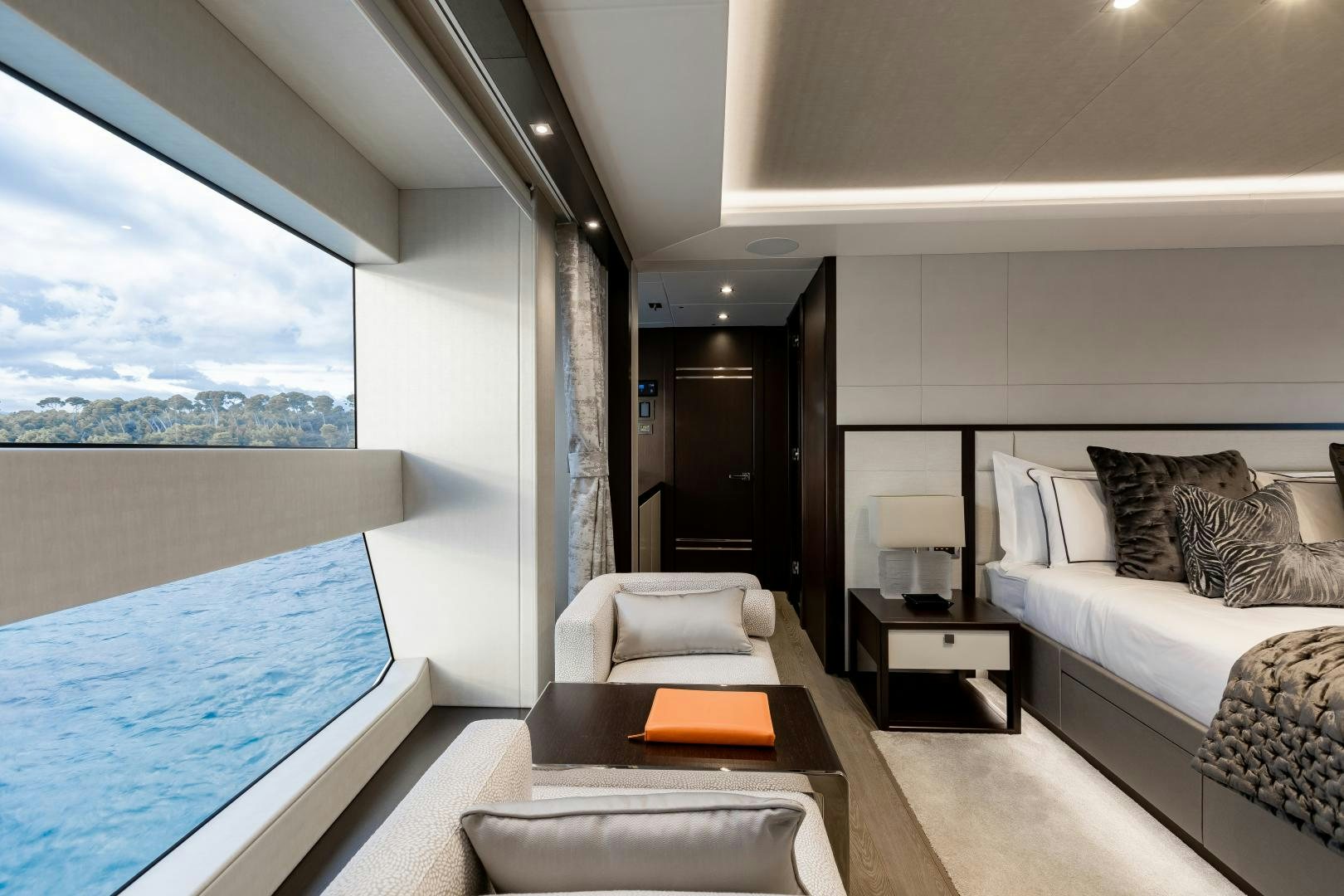 a room with a bed and a large window aboard SEDATIVE Yacht for Sale