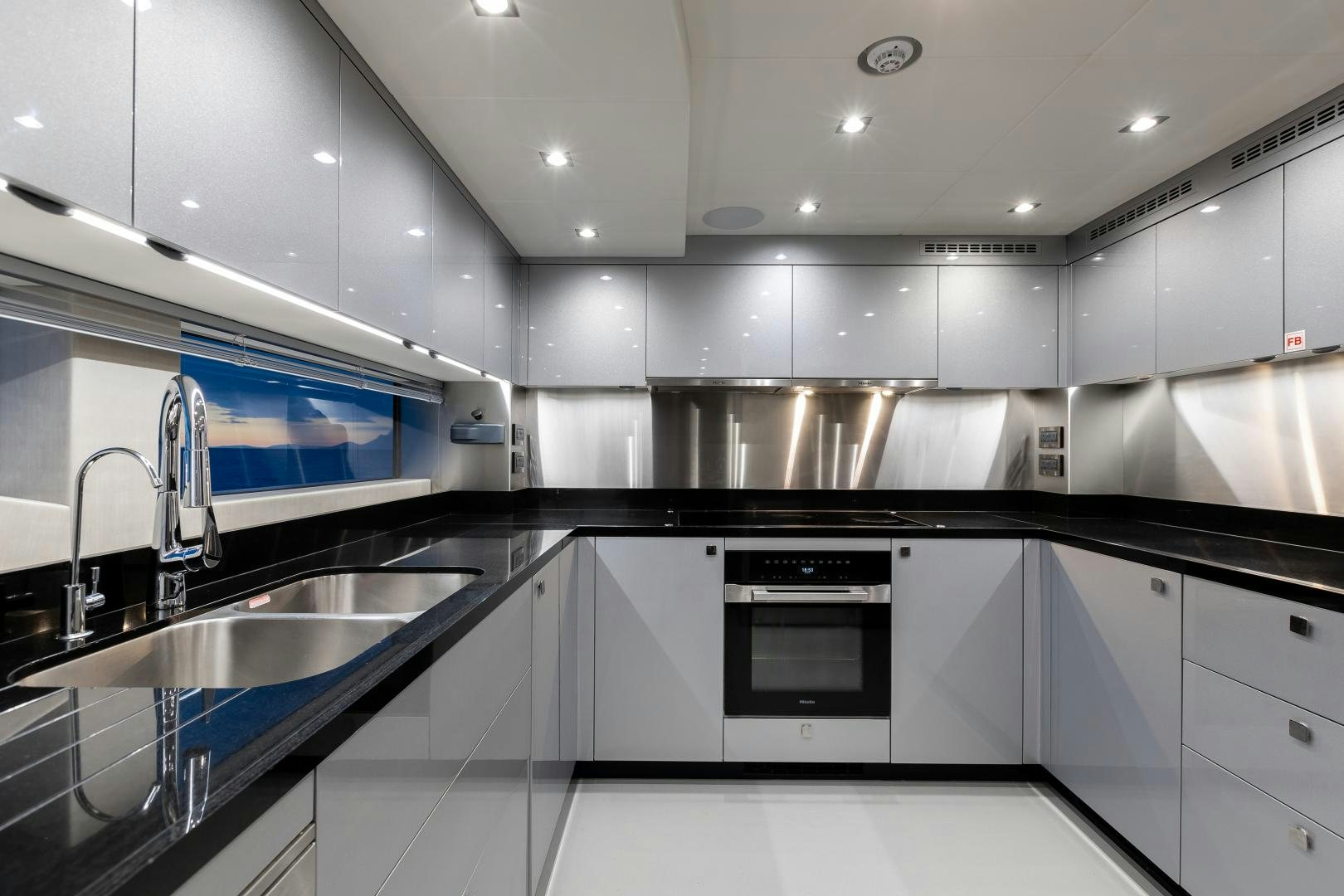 a kitchen with a sink and a stove aboard SEDATIVE Yacht for Sale