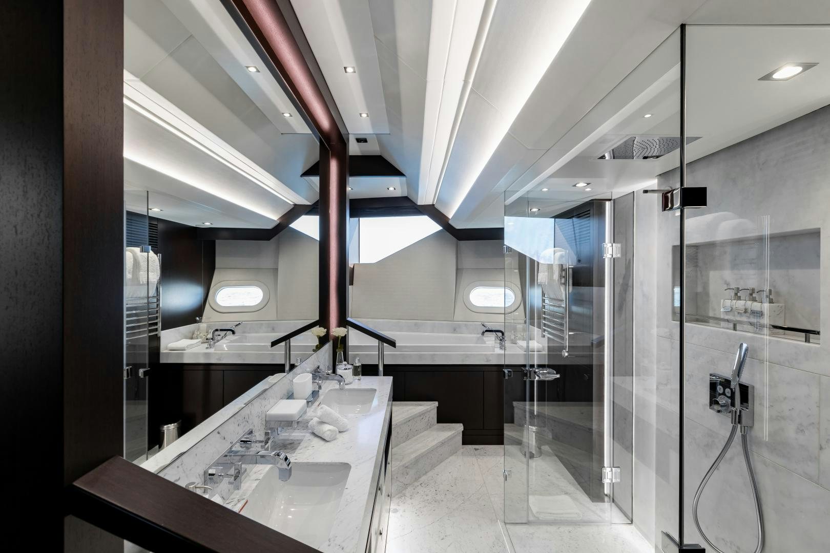 a large bathroom with a large mirror aboard SEDATIVE Yacht for Sale