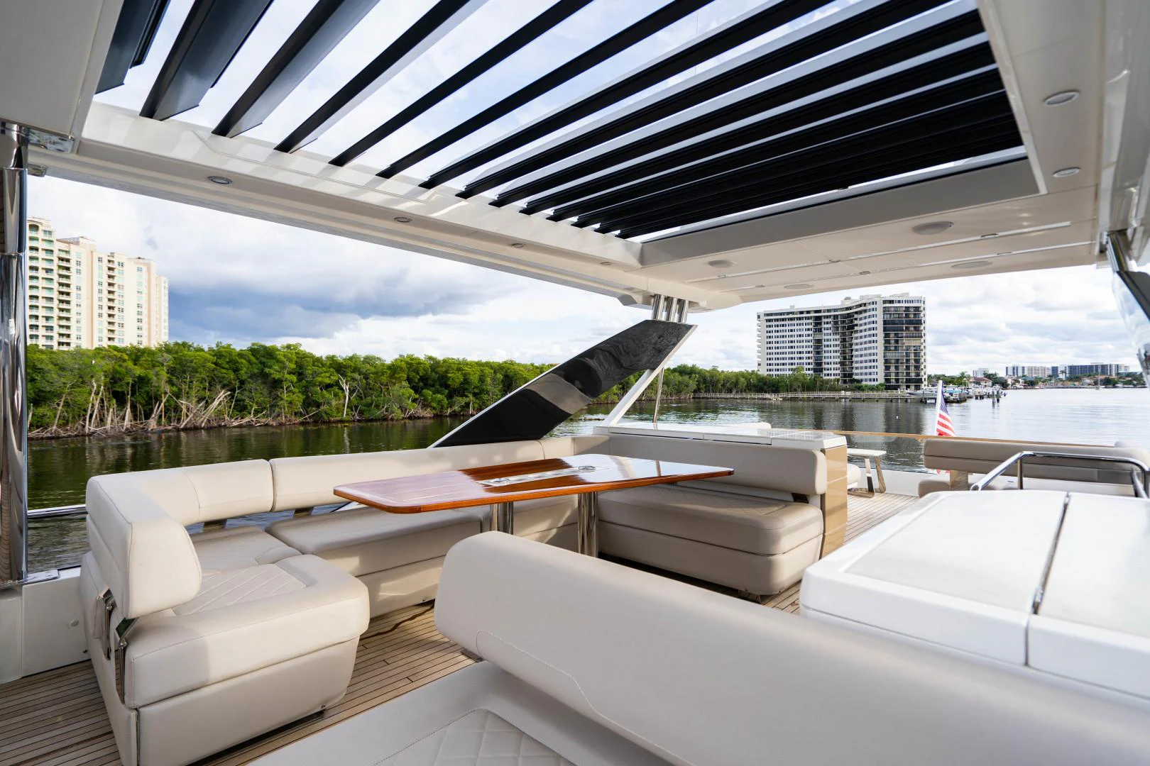 a room with a pool table and chairs and a large building with trees aboard BLIND DATE Yacht for Sale