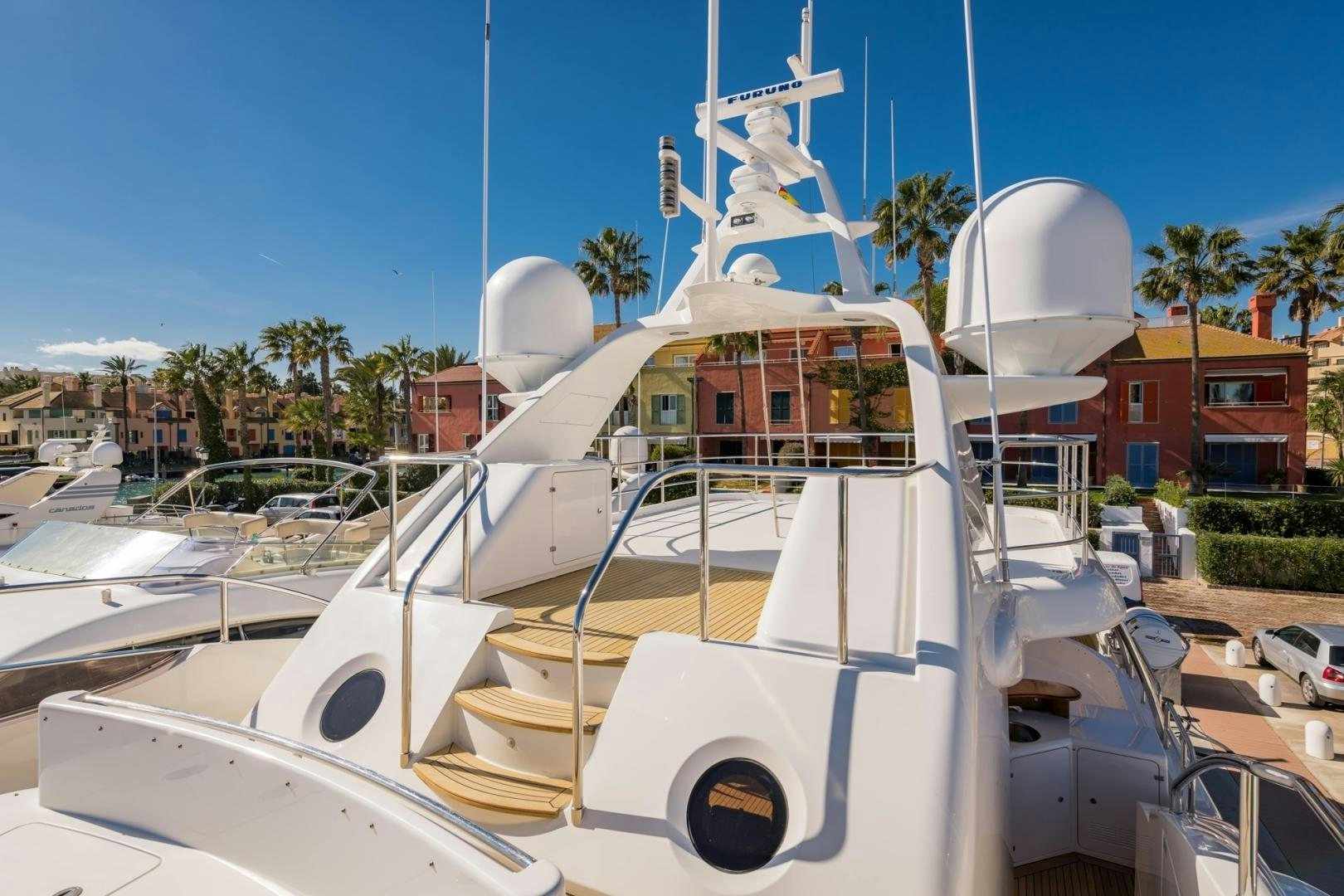 a white boat in a harbor aboard LA BELLA SARA III Yacht for Sale