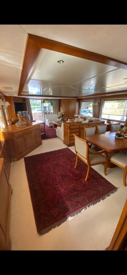 a large living room with a red rug aboard LA BELLA SARA III Yacht for Sale