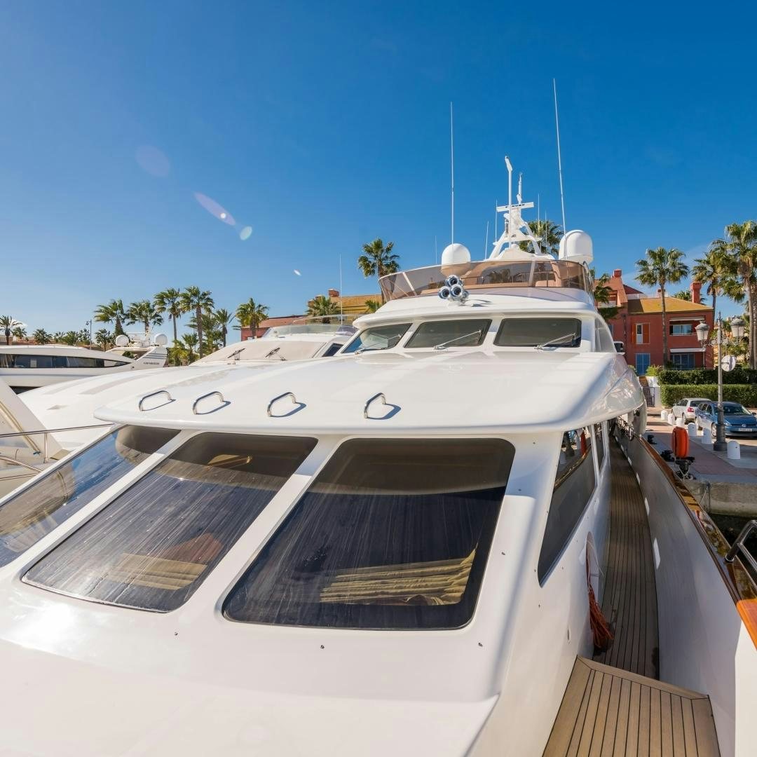 a white yacht on a dock aboard LA BELLA SARA III Yacht for Sale