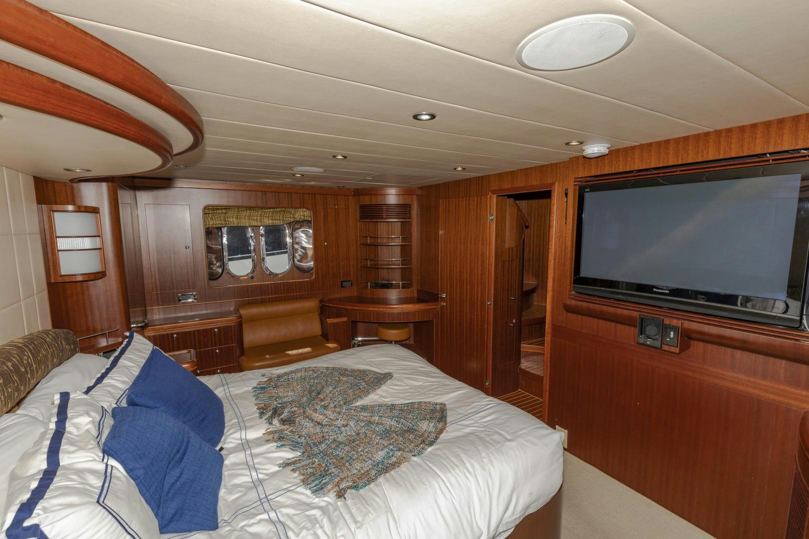 a bedroom with a large television aboard VIAGGIO Yacht for Sale